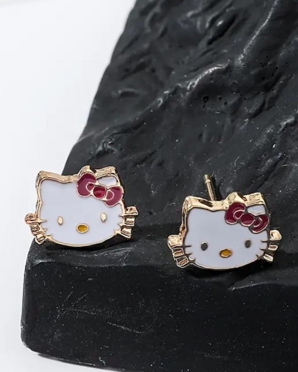 Cute Hello Kitty gold earrings with white cat face design, red bow and soft luxury finish