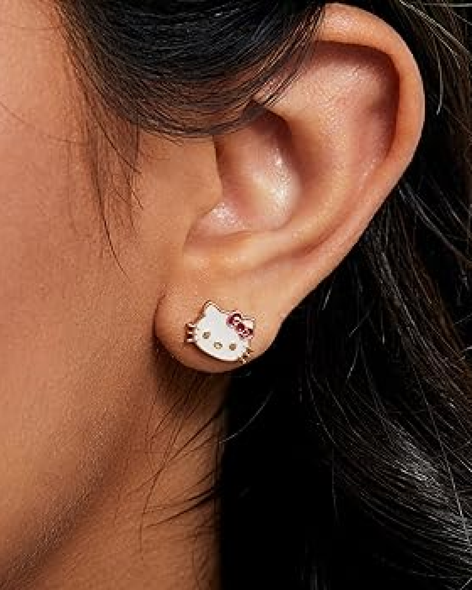 Hello Kitty Gold Outline Cat Earrings worn as chic everyday kawaii jewelry with subtle sparkle