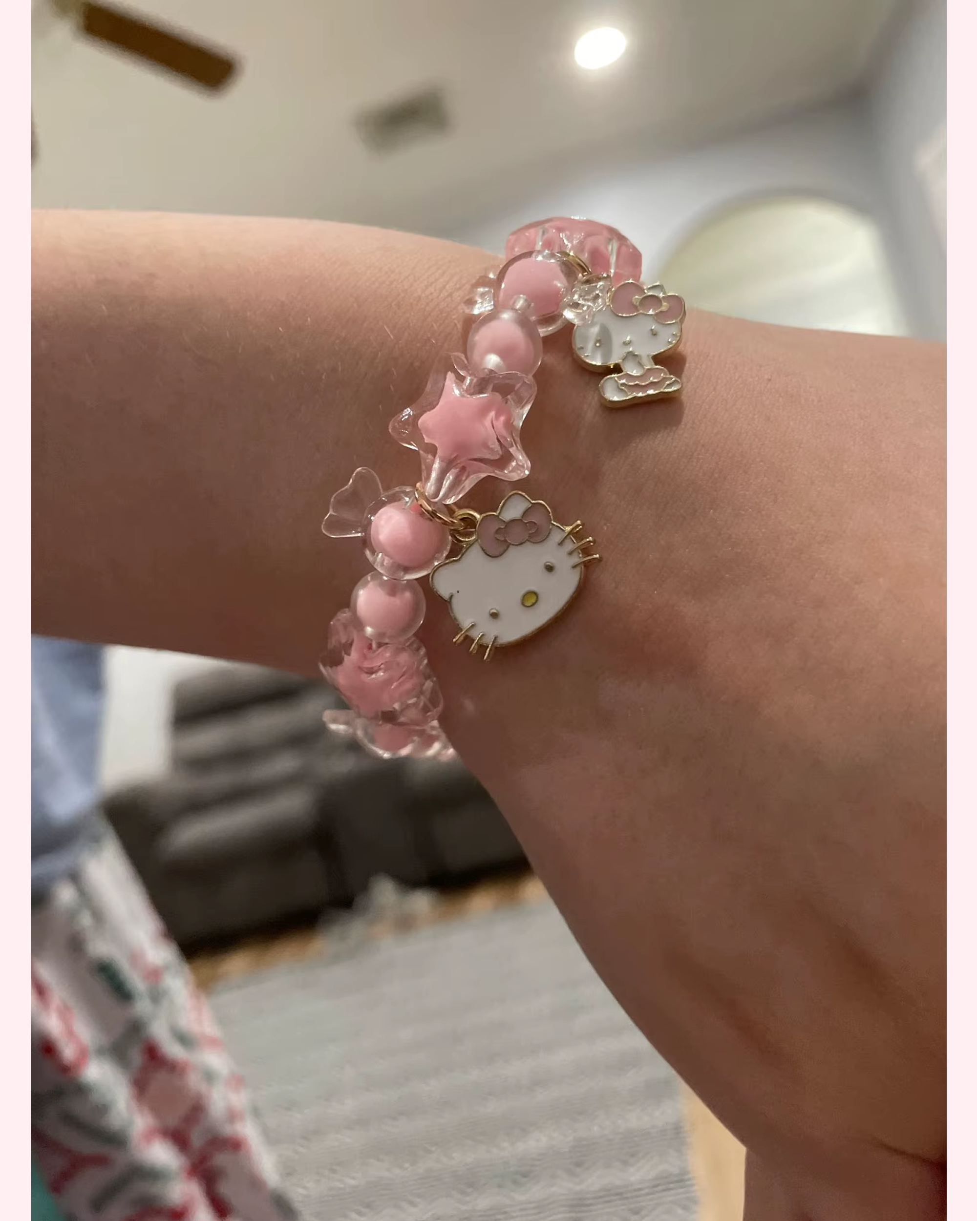 Pastel pink Hello Kitty bracelet with candy-style star charms and adorable cat-face details