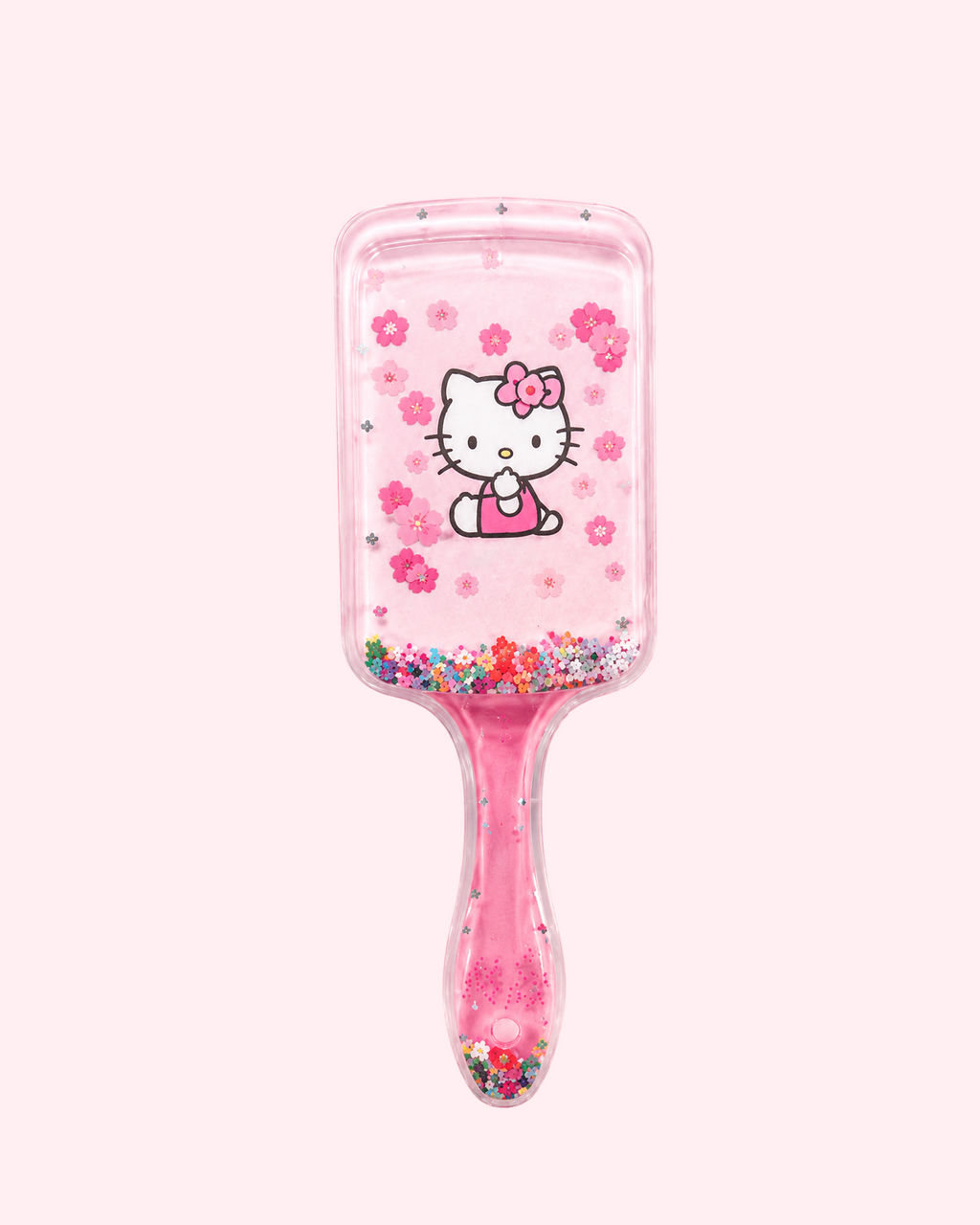 Cute pink Hello Kitty hair brush with transparent handle, kawaii print and playful glitter design