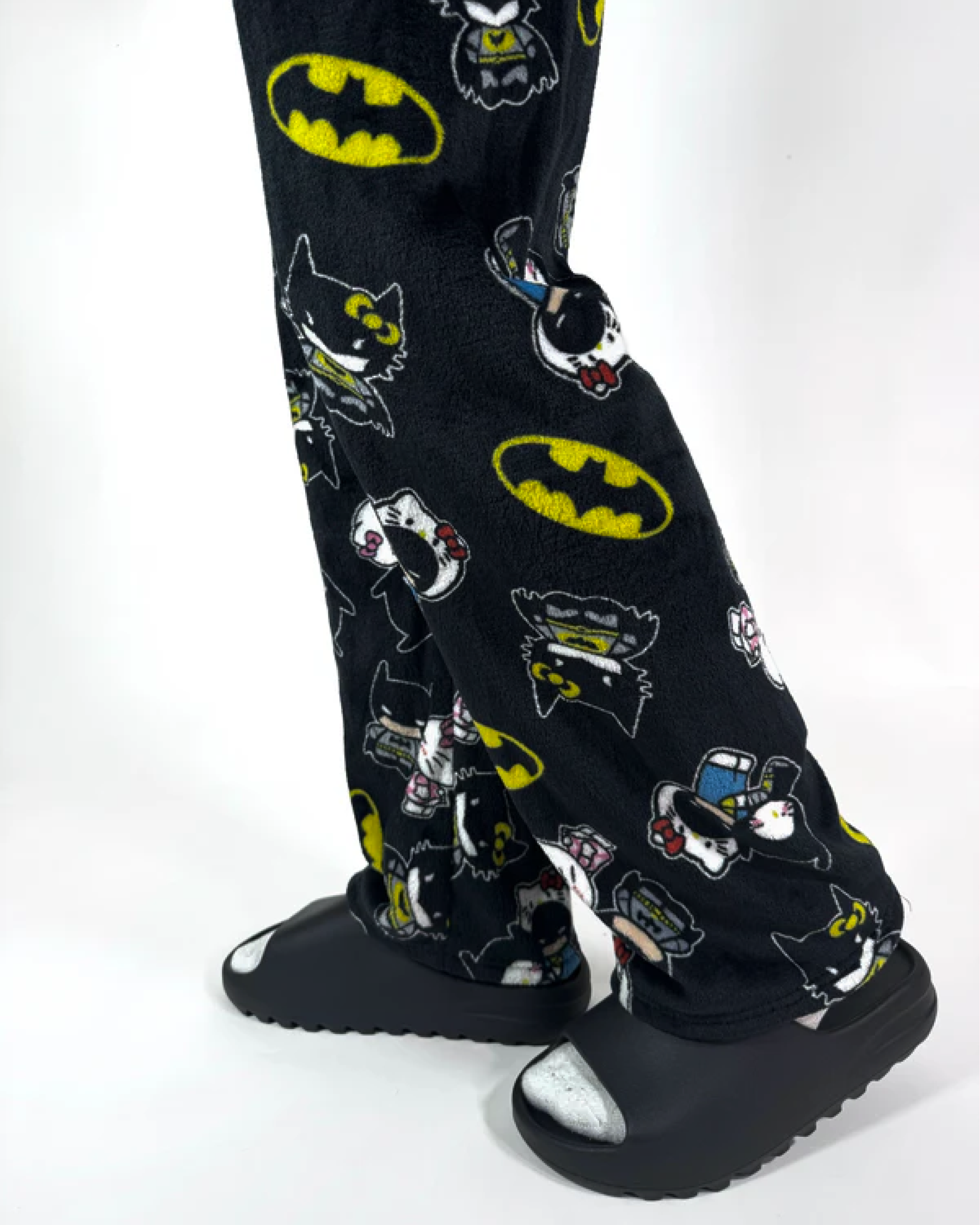 Dark hero-inspired Hello Kitty pajama pants with kawaii print