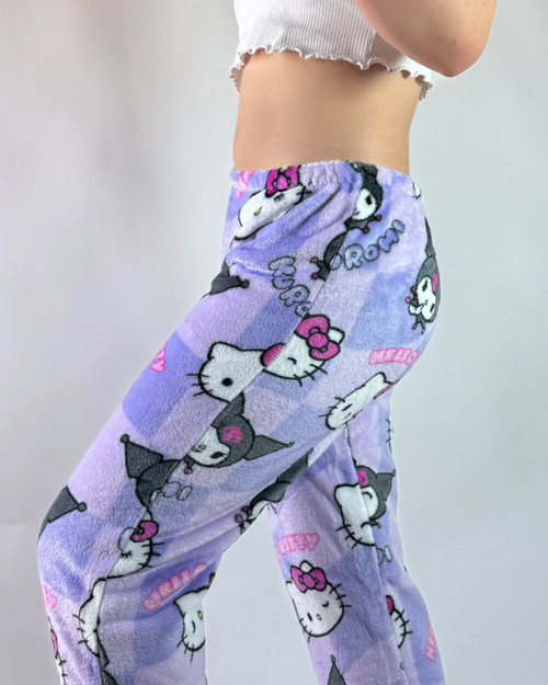 Purple Hello Kitty and Kuromi pajama pants with character faces all-over print