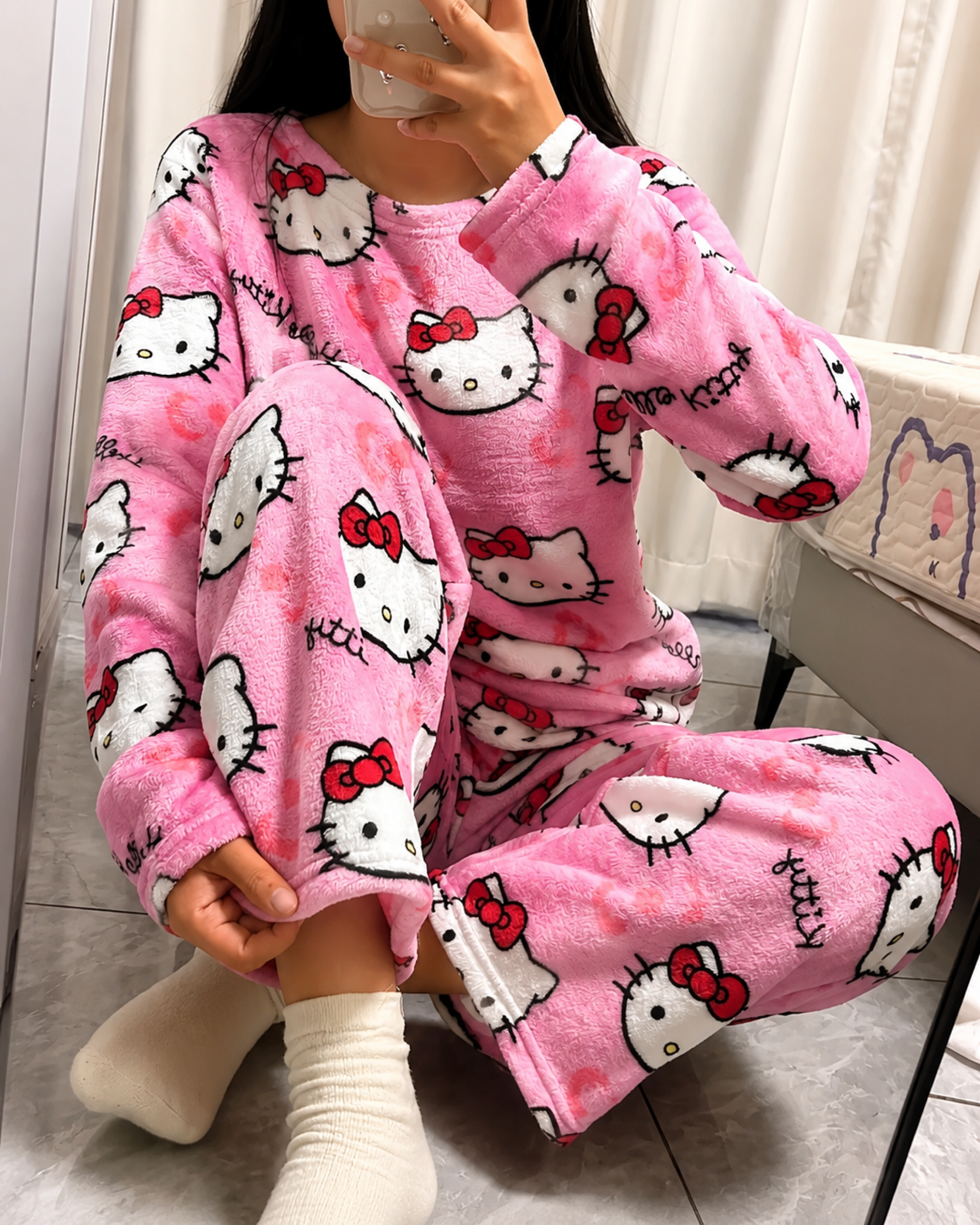 Close-up of Hello Kitty pink pajama pants print