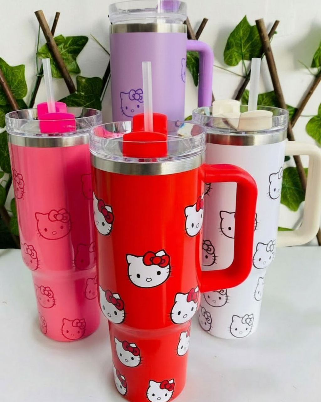 Red Hello Kitty drink tumbler with straw lid, handle and playful all-over kawaii design