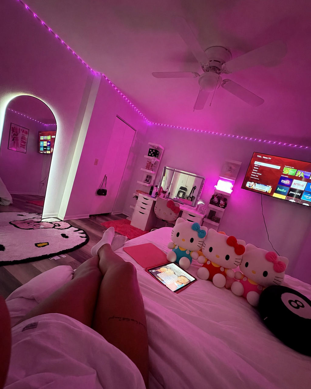 Red and yellow Hello Kitty plush displayed in a cute bedroom as cozy kawaii room decor